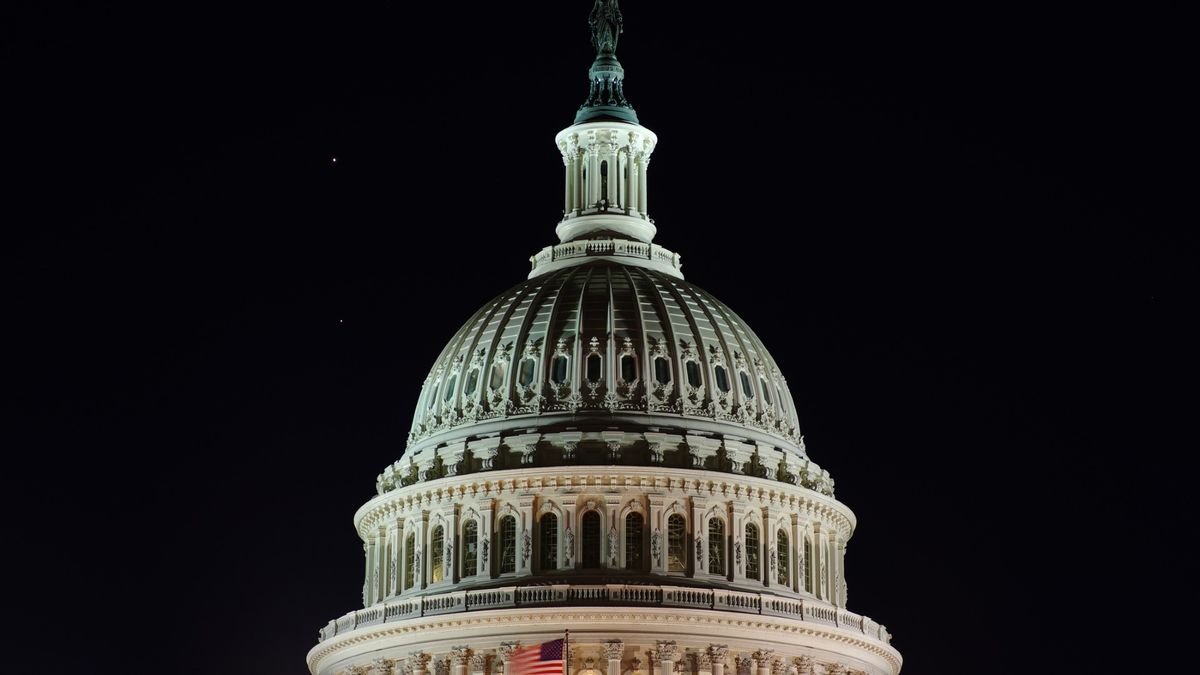the white dome of the us capitol building is lit up at night