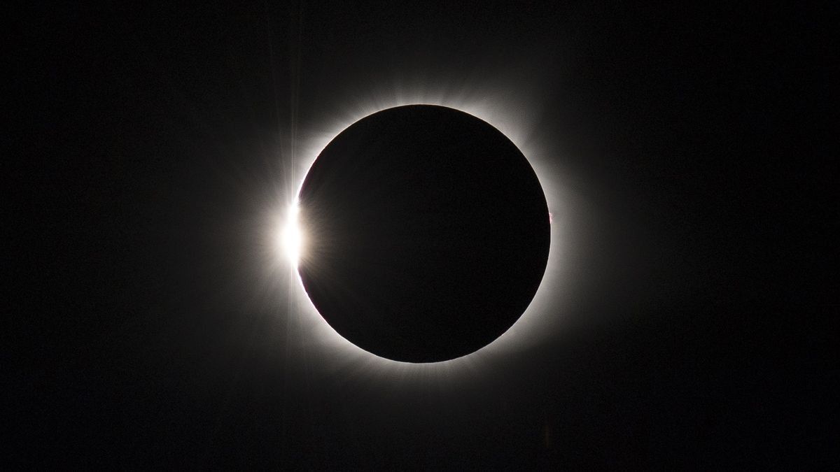 total solar eclipse on Aug 21 2017 appearing as a dark circle surrounded by a halo of white light