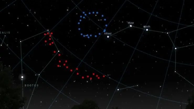 A view of the sky with one dotted blue circle toward the top center and a dotted red art to the middle left