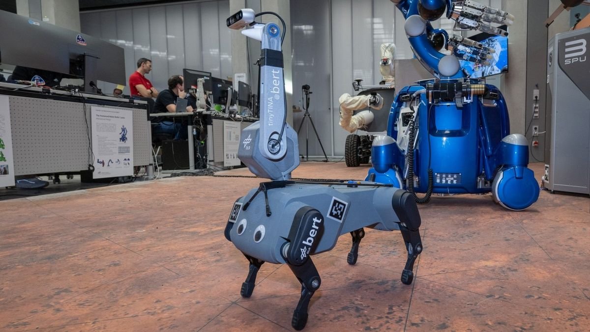 a four legged dog shaped robot with googly eyes and a thick antenna serving as a