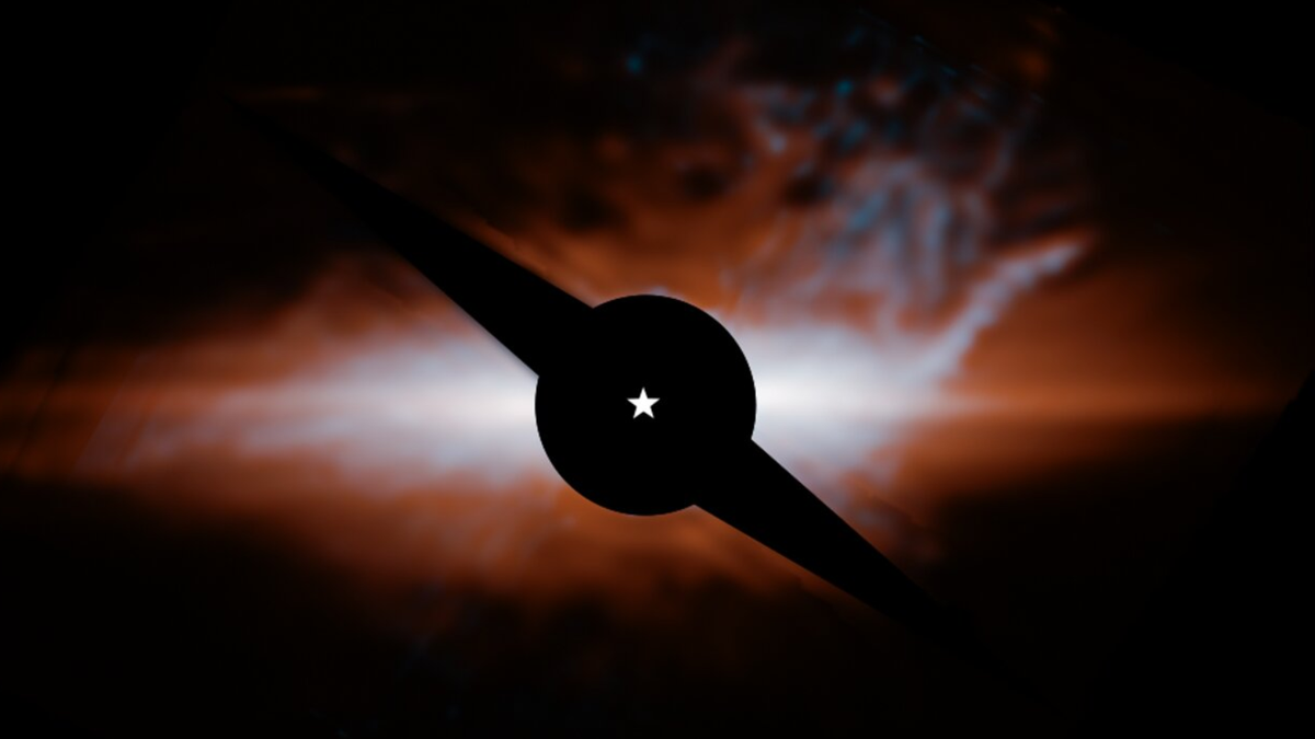photo showing a large reddish orange dust cloud in deep space