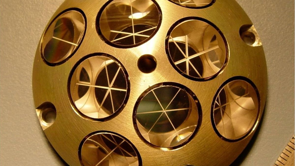 a gold metal orbcircle with other circles within inside each are three bisecting lines all tones of gold