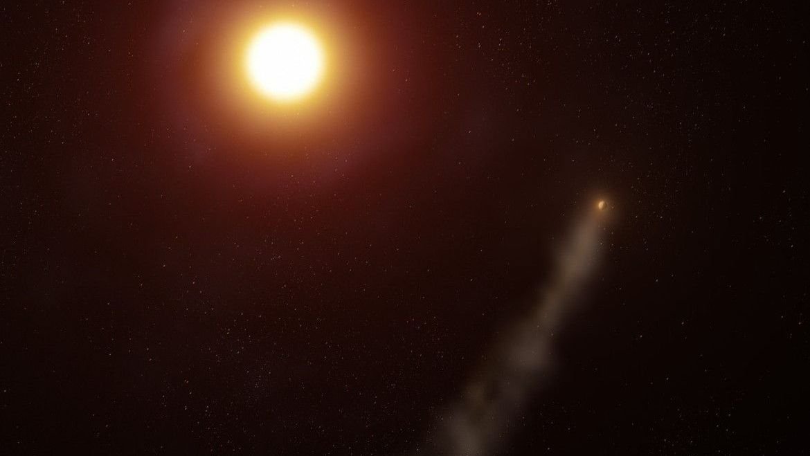 An alien planet trailing a long comet like tail around red orange star