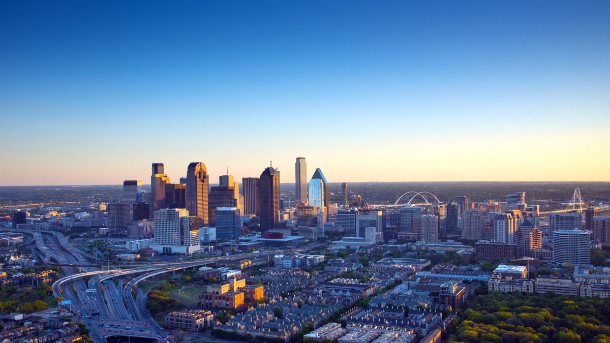 The Dallas skyline is a colorful landscape in late afternoon light Interstates 45 and 35 converge in a orderly design