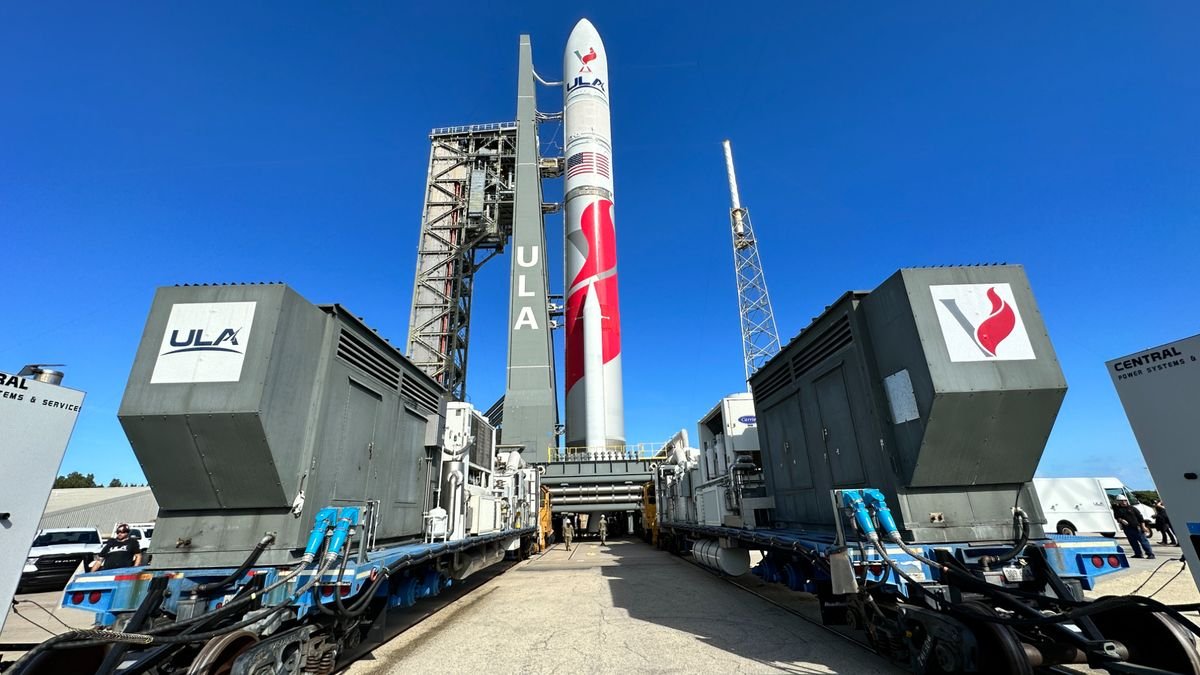 a red and white rocket stands against a blue sky