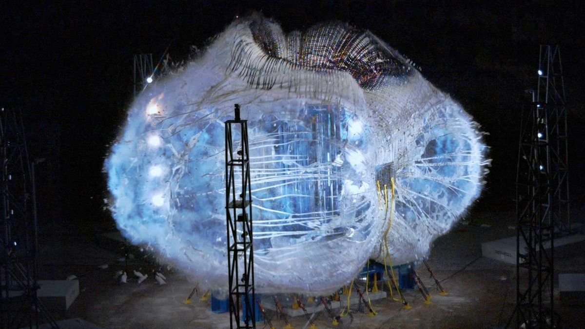 a balloon like habitat stretched to its limit inside a dark facility