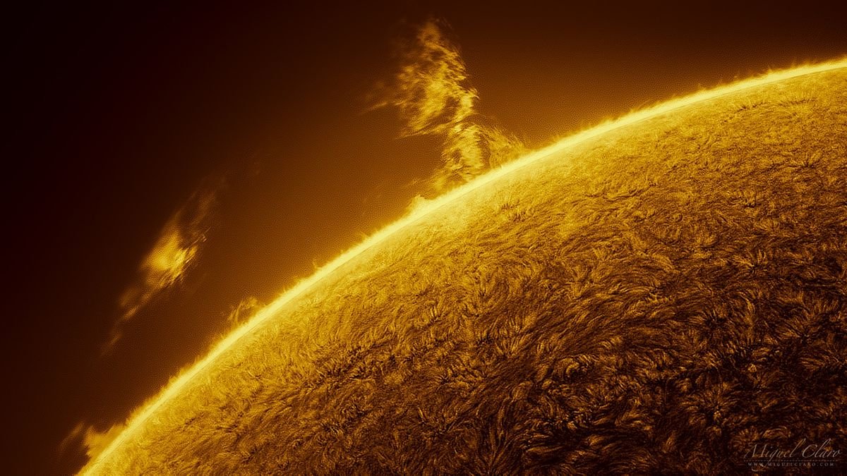 a close up image of the sun showing a giant tower of fiery plasma erupting from its surface