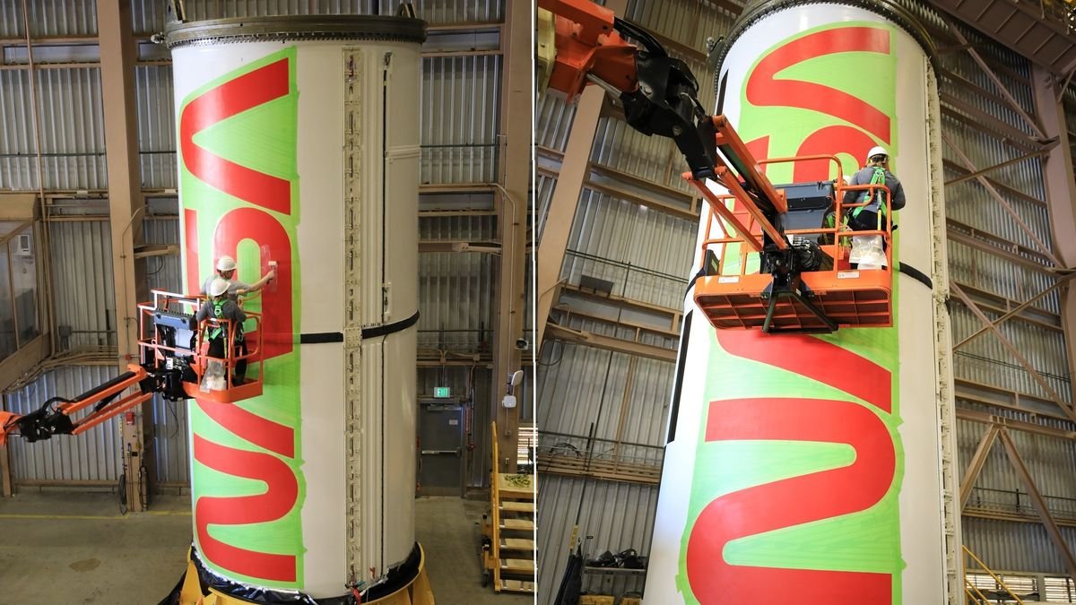 two views of a person on a crane painting the letters of