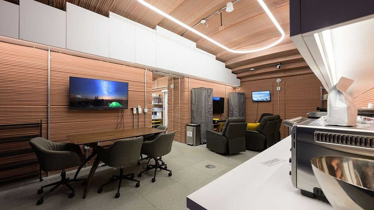interior of a nasa mock mars base with meeting space kitchen and futuristic lighting