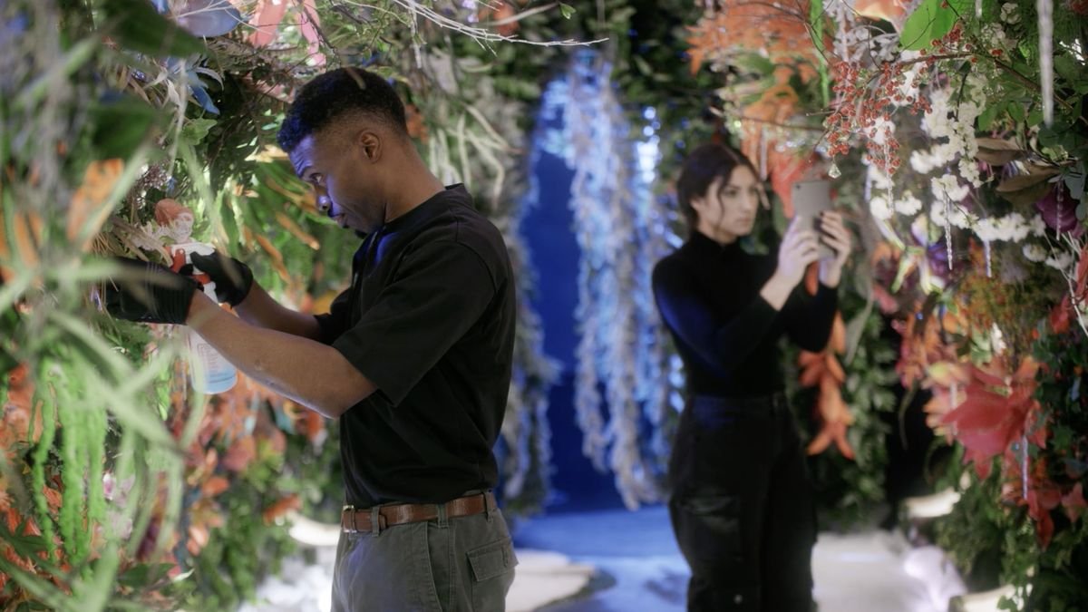 Two people tending to plants in a futuristic locale