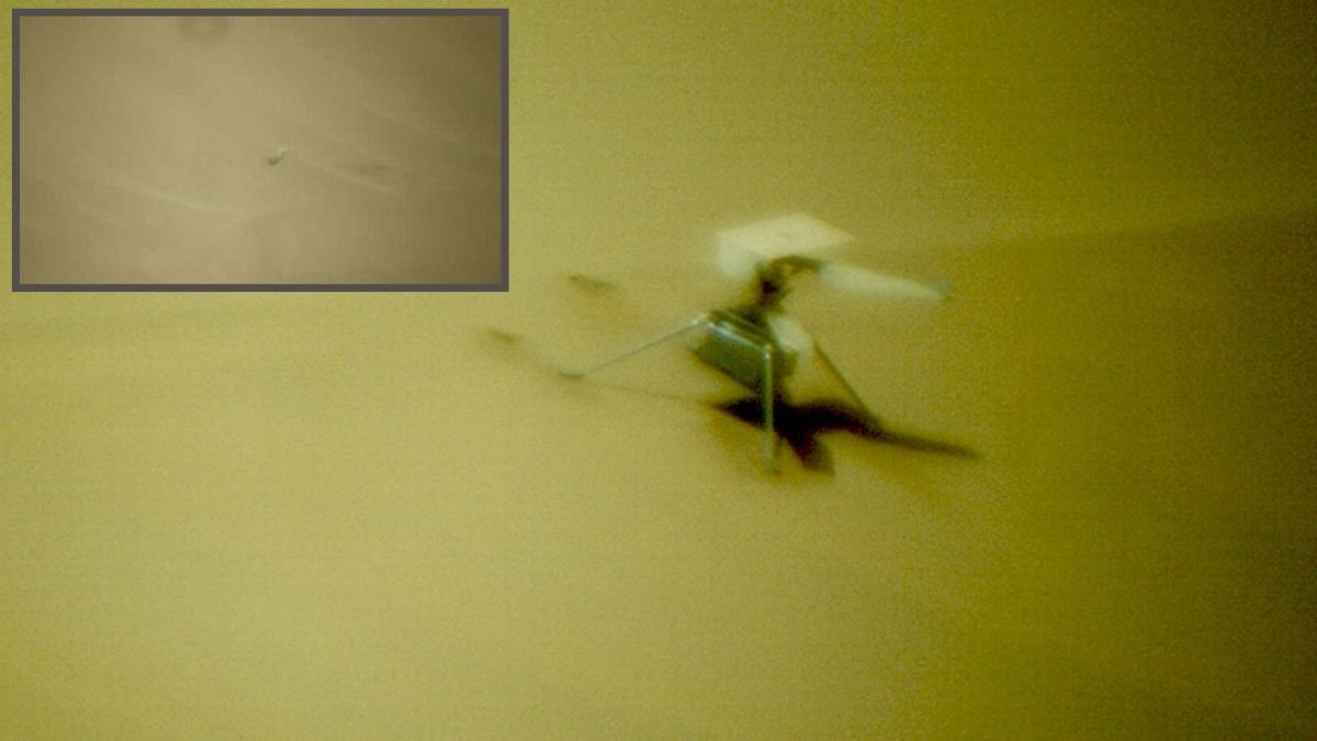 a blurry helicopter visible on the surface of mars an inset image shows a blade on the sand
