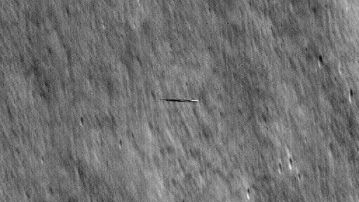 A dark streak over the moon as seen by a NASA spacecraft