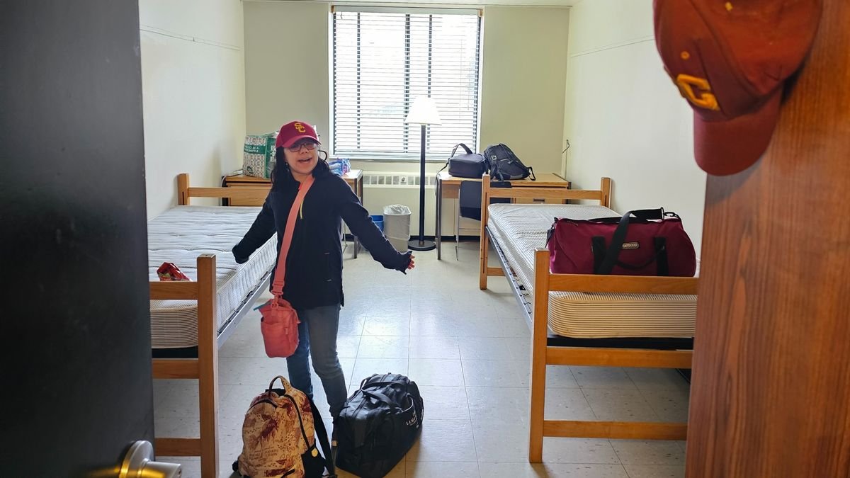 A girl poses inside a dorm room at SUNY Potsdam in New York