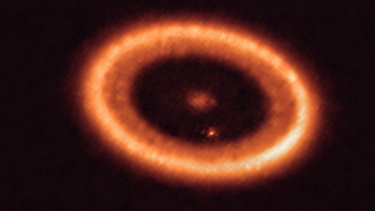 blurry orange concentric rings surround a central star in deep space