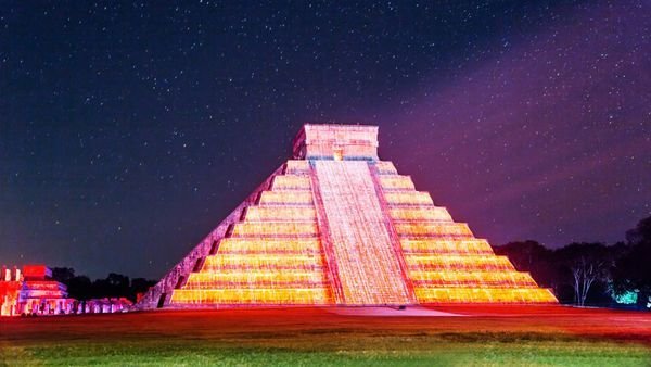El Castillo pyramid illuminated at night under a starry sky in Chichen Itza Mexico one of the largest Maya cities