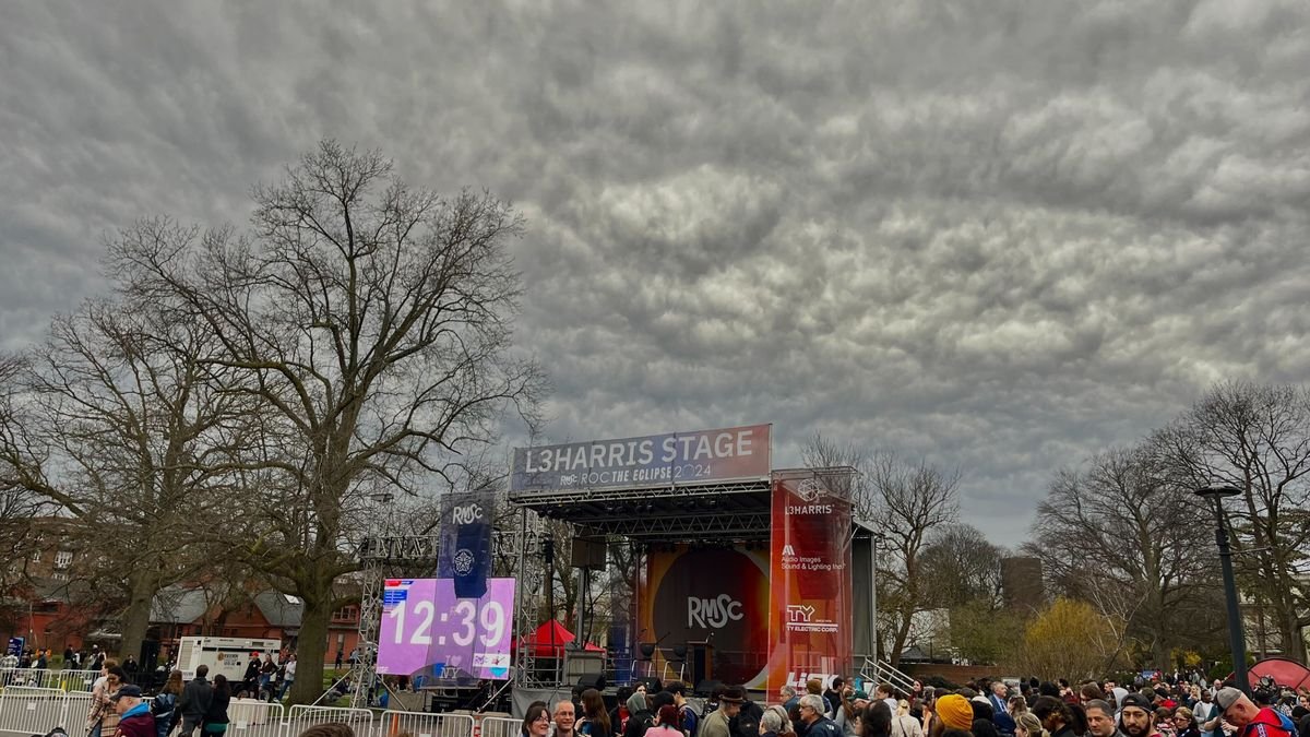 A cloudy sky above a stage and crowd