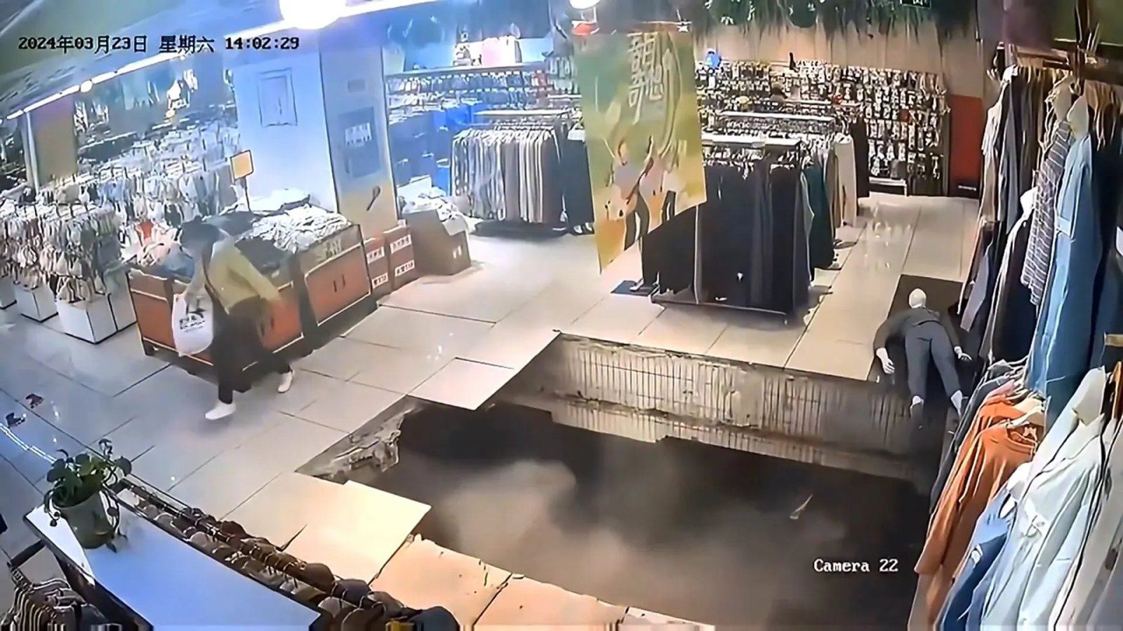 WATCH Woman falls through floor as possible sinkhole opens up under shopping mall