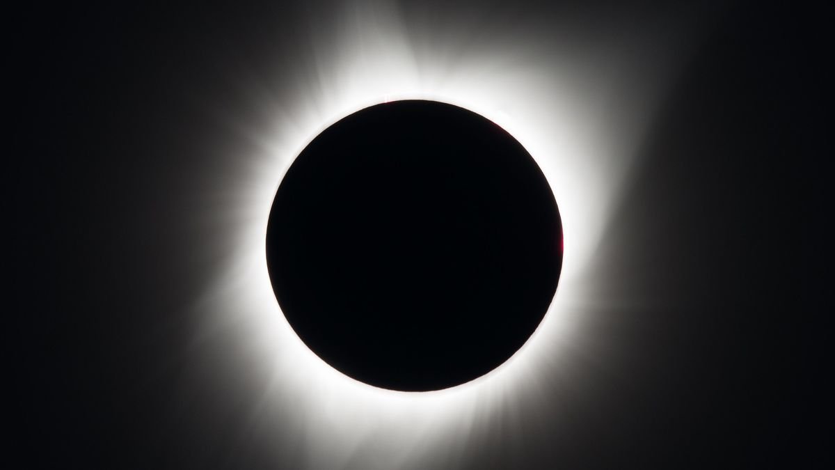 closeup photo of the moon blocking the sun during a total solar eclipse