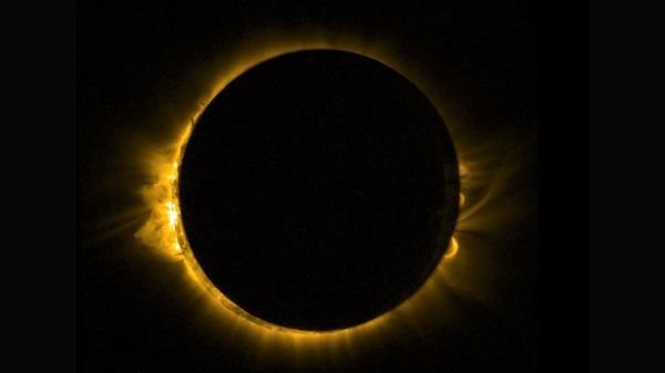 photo of a solar eclipse showing the moon blotting out the sun except for a thin yellow orange ring around the outside