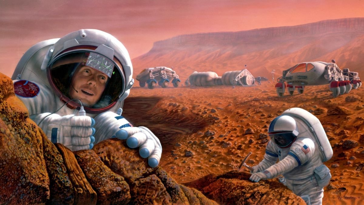 Two people in spacesuits walk the surface of a rust colored planet The astronaut in the foreground looks at something far away in wonder The astronaut to the right and slight behind leans on a rock formation and holds a hammer A many wheeled rover is parked behind them and in the distance some habitat modules