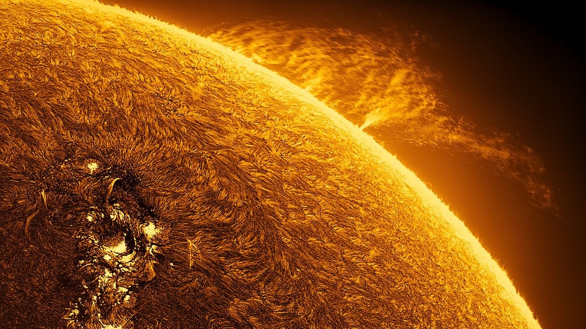 large arcs of fire reach out from the fiery surface of the sun