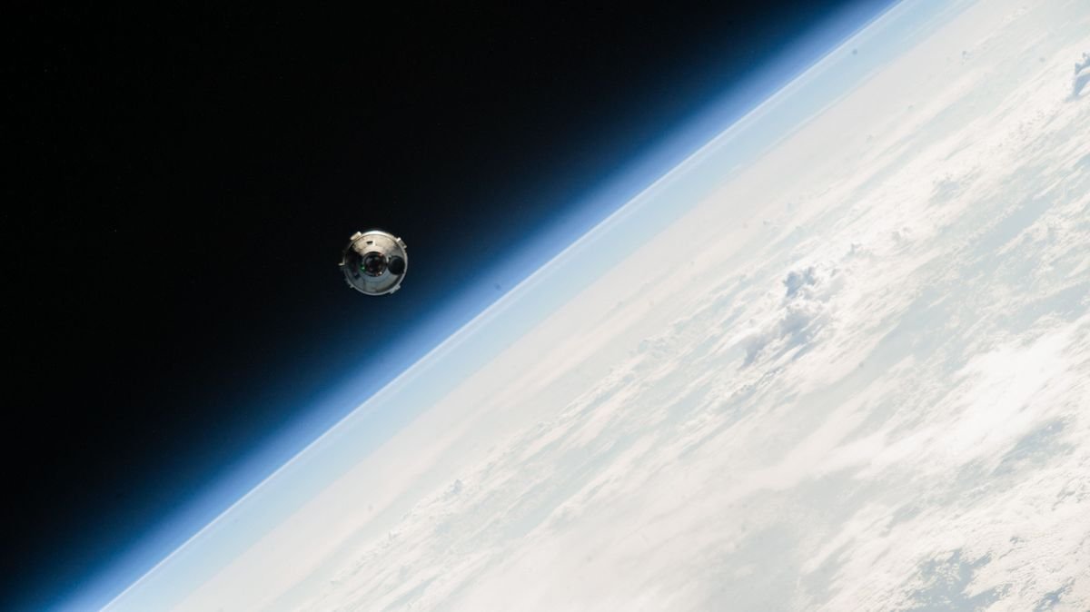 A white Boeing Starliner spacecraft floats above a blue Earth against the black of space on June 6 2024