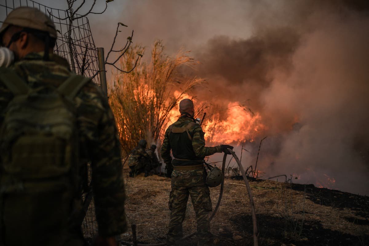 Greece fires: Athens seaside town evacuated as strong winds spread deadly fire