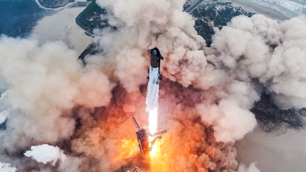 drone's-eye view of a giant rocket launching from a seaside pad, generating a huge plume of dust and exhaust