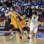 Christian Manaytay and Nic Cabañero headed to the UST Growling Tigers bench during a UAAP Season 87 men's basketball game.