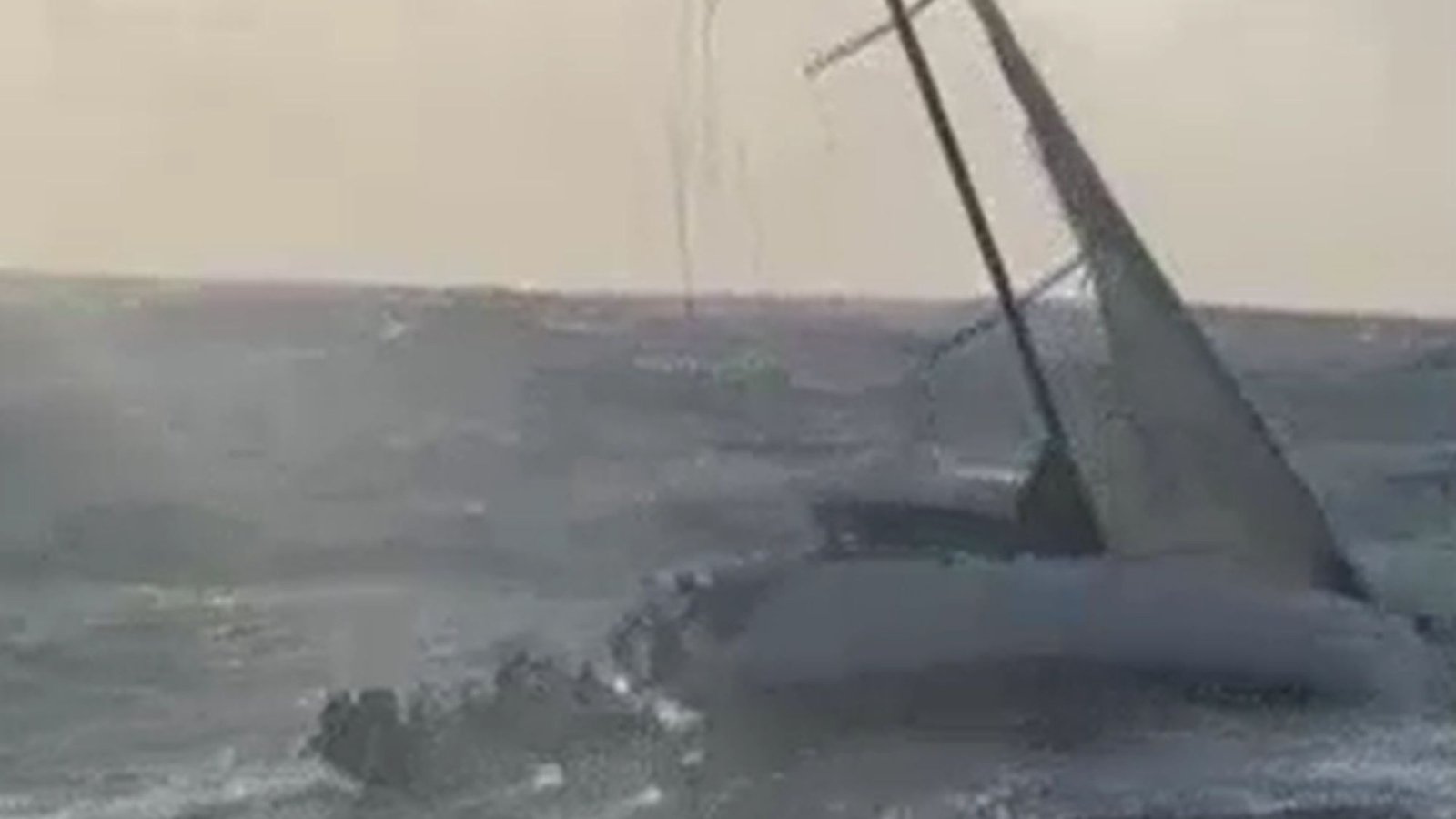 Watch heart-stopping moment couple cling for life to side of yacht after 24 hours being battered by 20ft waves