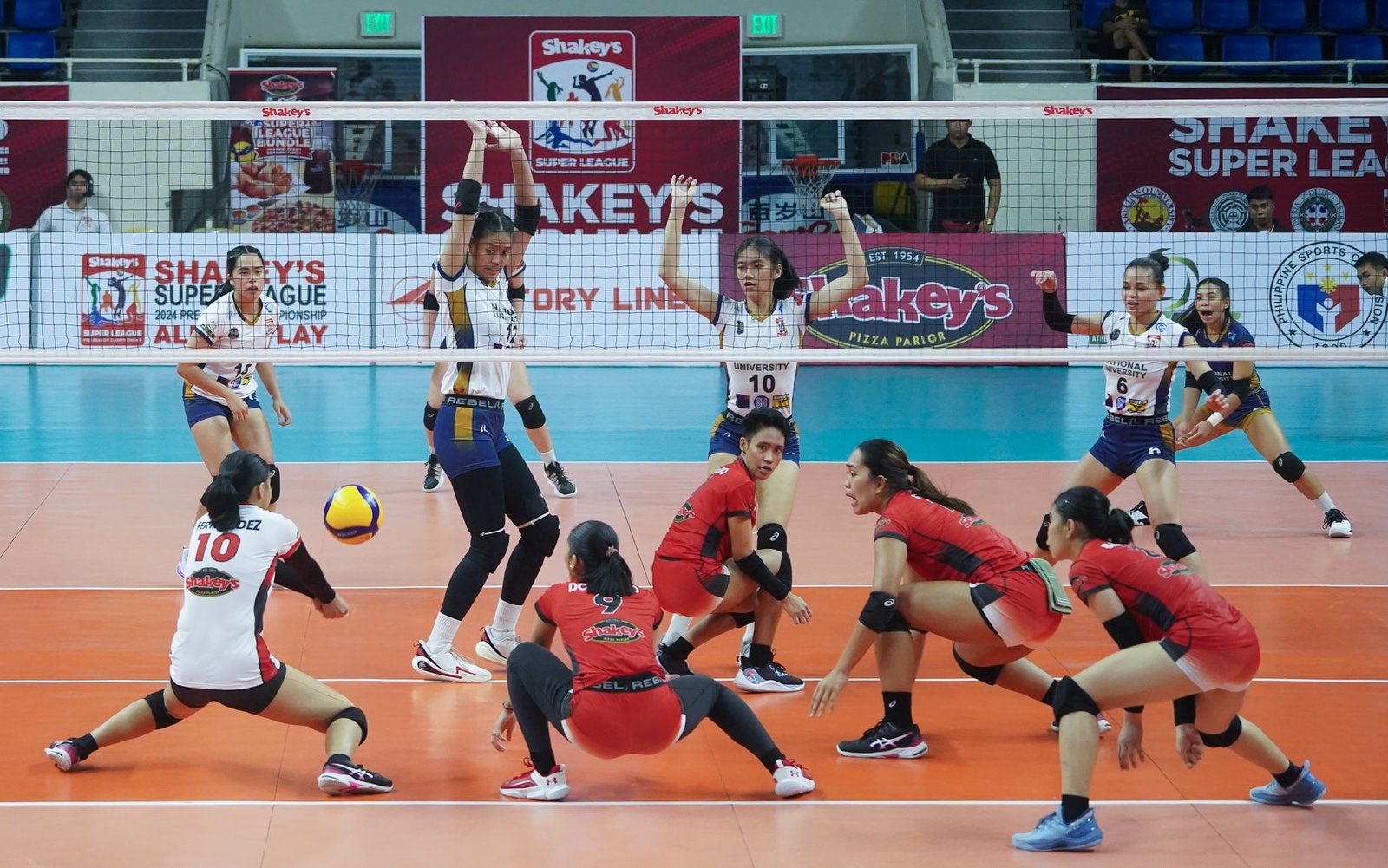 SITTING DUCKS. Gracen Fernandez of UE try to save the ball off the NU Lady Bulldogs during a 2024 Shakey’s Super League Collegiate Pre-season Championship game. NU beat UE in three sets