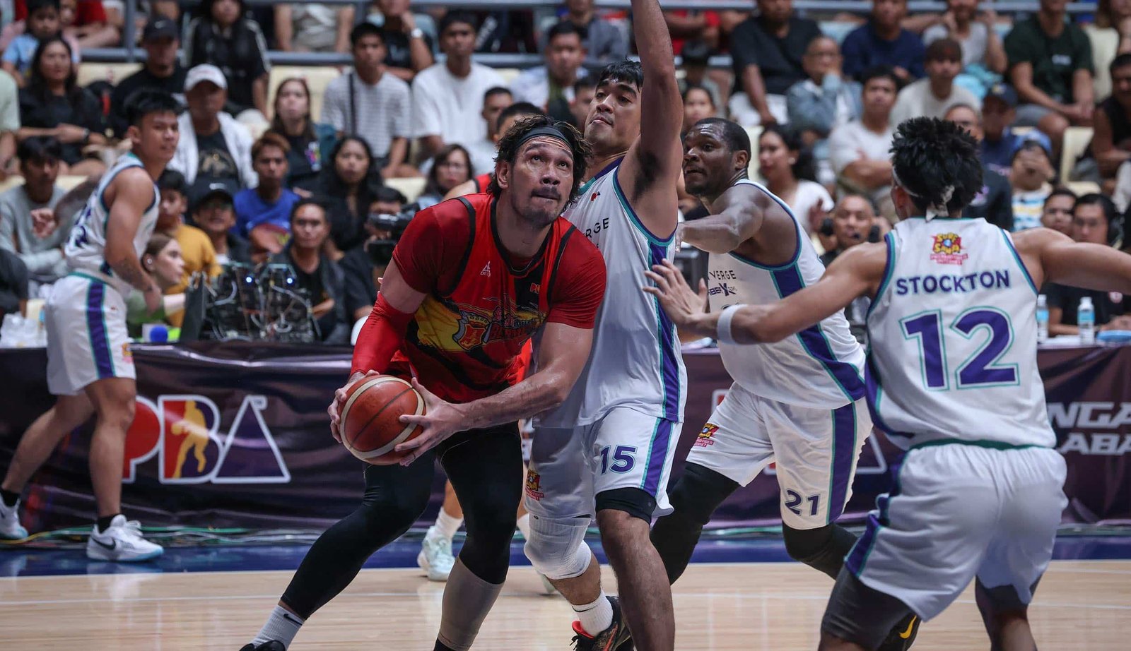 San Miguel Beermen's June Mar Fajardo with a teardrop shot over Converge defenders during the PBA Governors' Cup quarterfinals.