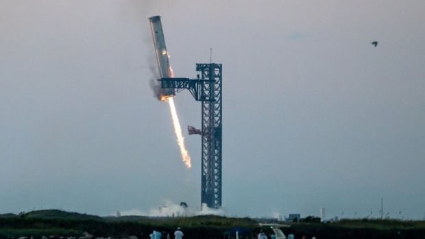 Launch tower's 'chopsticks' catch descending rocket booster as SpaceX launches Starship