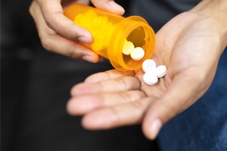 Man Pouring Drugs into Hand Medicine Aspirin