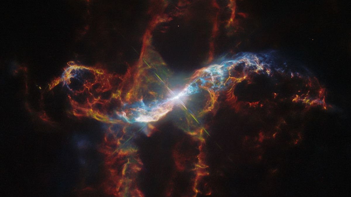 space telescope photo of a nebula in deep space, with a bright white star at the center of an orange gas cloud