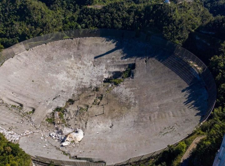 An aerial view of the massive radio dish at Arecibo Observatory after the telescope's collapse.