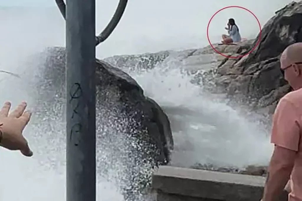 Horror moment tourist sitting on rocks above sea is swept off her yoga mat and drowns