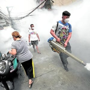 REMAIN CALM AND CARRY ON A health worker spraysinsecticide as part of the country’s fight against dengue.