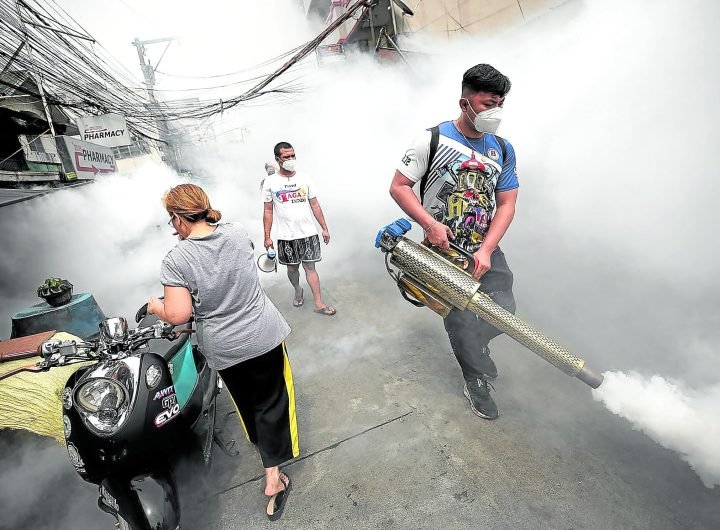 REMAIN CALM AND CARRY ON A health worker spraysinsecticide as part of the country’s fight against dengue.