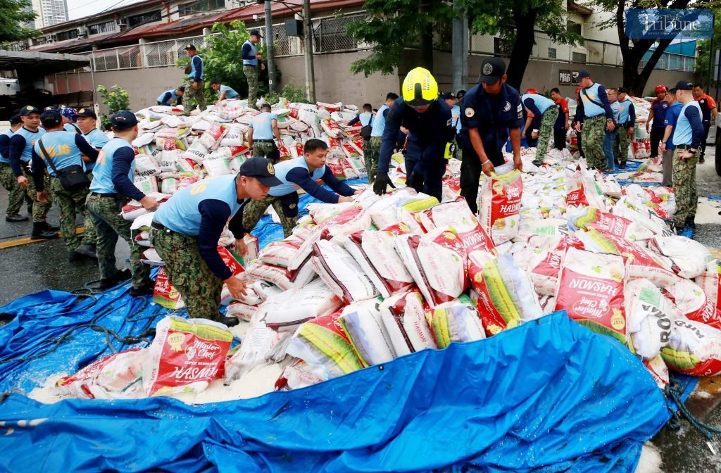 PNP and MMDA clear scattered rice after truck-motorcycle collision