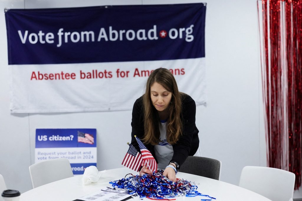 Paige McKinnon from California arranges flags at the Democrats Abroad pop-up campaign office in London, United Kingdom on Tuesday, November 5. #USVote