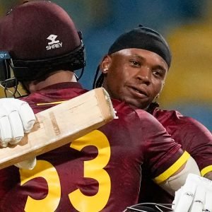 West Indies' Keacy Carty celebrates with teammate Brandon King scoring a century against England during the third ODI cricket match at Kensington Oval in Bridgetown, Barbados, Wednesday, Nov. 6, 2024. (AP Photo/Ricardo Mazalan)