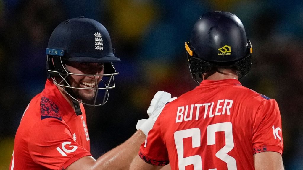 England's captain Jos Buttler and Will Jacks celebrate runs against West Indies during the second T20 cricket match at Kensington Oval in Bridgetown, Barbados, Sunday, Nov. 10, 2024. (AP Photo/Ricardo Mazalan)