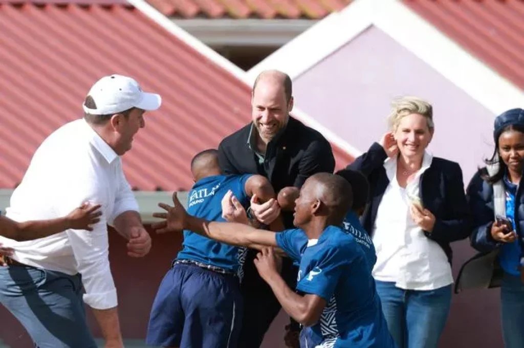 William grabbed by youngsters shouting 'tackle the prince' during rugby challenge