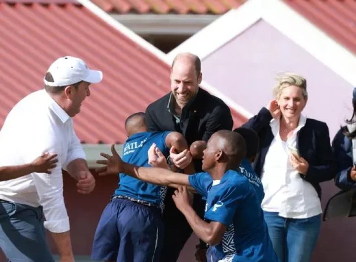 William grabbed by youngsters shouting 'tackle the prince' during rugby challenge