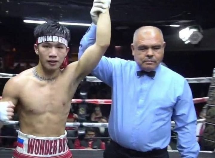 A boxing sensation from Lagawe, Ifugao, Carl Jammes Martin lands a right-left combination to the head that drops Mexican Juan Tostado in their super b