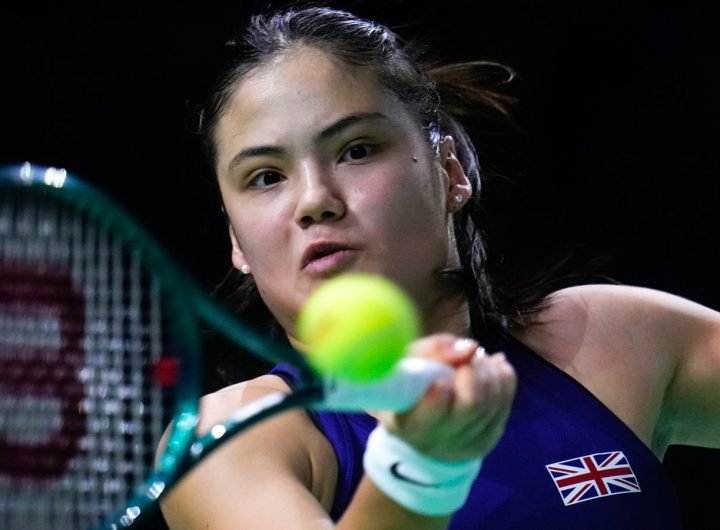 Great Britain's Emma Raducanu returns the ball to Slovakia's Viktoria Hruncakova during a Billie Jean King Cup semi-final match at Martin Carpena Sports Hall in Malaga, southern Spain, on Tuesday, Nov. 19, 2024. (AP Photo/Manu Fernandez)