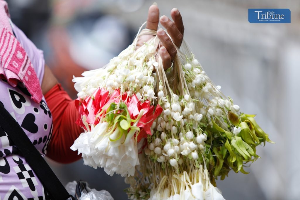 LOOK: A woman sells tied sampaguitas in Plaza Miranda, Manila. Devotees often place sampaguitas at shrines, crosses, and statues to show respect and d