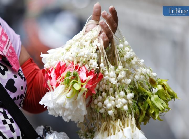 LOOK: A woman sells tied sampaguitas in Plaza Miranda, Manila. Devotees often place sampaguitas at shrines, crosses, and statues to show respect and d