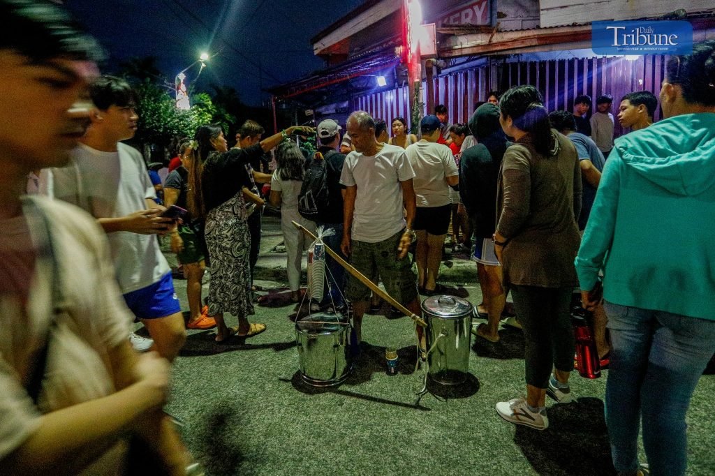 LOOK: Francis Baliola, 64, sells taho to devotees who attended the first Mass of Simbang Gabi at the Cubao Cathedral, Quezon City today. After finishi